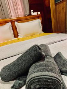 a persons legs are laying on a bed at Boutique Hotel Pavillon in Abidjan