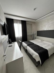 Postel nebo postele na pokoji v ubytování Hotel Plaza