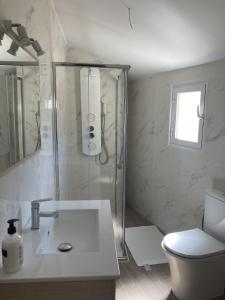 a bathroom with a shower and a sink and a toilet at San Sebastián 6 Apartments in San Sebastián de los Reyes