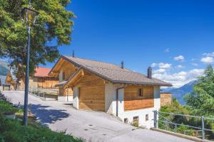 a house with a street light in front of it at Luxury Chalet: Alpine Magic with Terrace Views in Crans-Montana