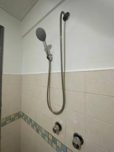 a shower with a shower head in a bathroom at 5-8 Pax BBQ-Super Sea View @ Port Dickson in Seremban