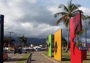 uma rua com sinais coloridos no lado de uma estrada em Pousada Do Léo em Bertioga