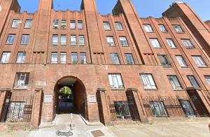 a large red brick building with an arch entrance at 3-Bed Apartment Central London - 15 Mins walk to Kings Cross by Seren Short Stays in London