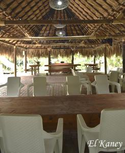 einen Essbereich mit weißen Stühlen und einem Tisch in der Unterkunft HERMOSA FINCA A 20 KM DE MEDELLIN LLENA DE NATURALEZA in Girardota