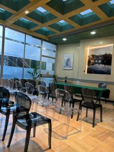 a room with a green table and chairs at Hotel Plaza in Turin