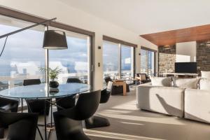 a living room with a couch and a table and chairs at Villa Vel Aegina in Vaia