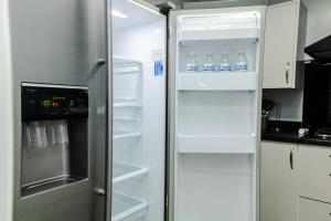 a refrigerator with its door open in a kitchen at Large Home - FREE PARKING, BUSINESS STAYS, RELOCATORS, FAMILIES in Stockton-on-Tees
