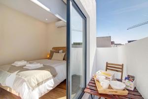 a bedroom with a bed and a table with dishes on it at Bougainvillea House in Faro