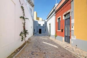 an alley in an old town with buildings at Bougainvillea House in Faro