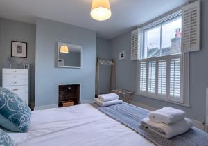 a bedroom with a bed with towels on it at Fern Cottage - Whitstable in Whitstable