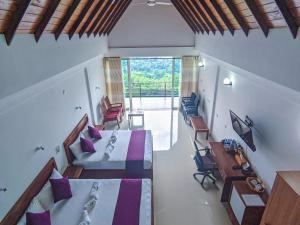 a bedroom with two beds and a table and chairs at Terrace Cinnamon View in Ratnapura