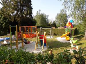 a playground with a bunch of play equipment in a yard at Camping Smile & Braudieres in Mézières-sous-Lavardin