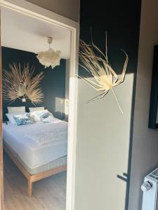 a bedroom with a bed with white sheets and decorations at Le Rêve in La Roche-en-Ardenne +18 photos