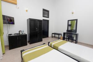 Postel nebo postele na pokoji v ubytování Indra Manel Family Holiday Resort Kandy