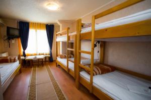 a room with two bunk beds and a desk at Vila Livadeto in Troyan