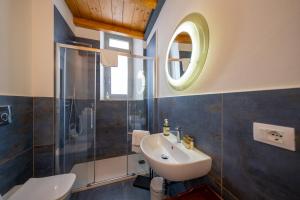 a bathroom with a sink and a toilet and a window at Lungarno Buozzi 7 Apartments in Pisa +107 photos