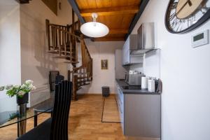 a kitchen with a counter and a clock on the wall at Lungarno Buozzi 7 Apartments in Pisa