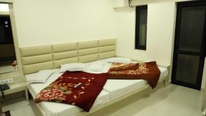 a bed in a room with a large bed sidx sidx sidx at Hotel Sahil 4 Min Distance from Dargah in Ajmer