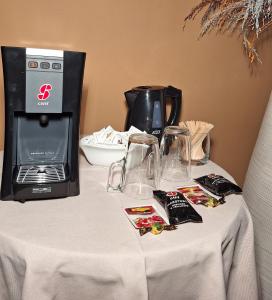 a table with a coffee maker and a toaster at Guest Accommodation Primula in Nova Gorica