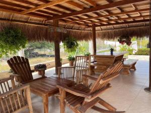 una mesa de madera y sillas bajo una pérgola de madera en El Mejor Lugar para descansar cabaña OASIS, en San Antero