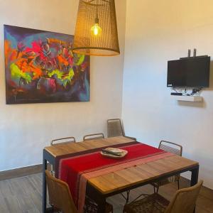 Villa Narcisa في بورماماركا: طاولة غرفة الطعام مع بطانية حمراء عليها