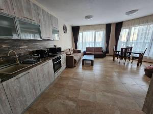 a kitchen and living room with a couch and a table at Elegantz Apartments 2 in Varna City