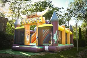a childs play park with a bouncy castle at Camping le Colorado in Rustrel