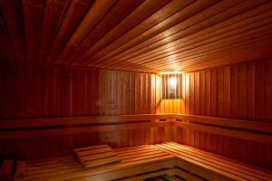 an empty wooden sauna with a light in it at Garda Suite Hotel in Limone sul Garda