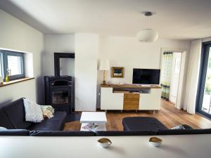 ein Wohnzimmer mit einem Sofa und einem TV in der Unterkunft Ferienwohnung Seeufer in Kressbronn am Bodensee