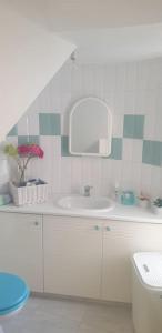 a bathroom with a sink and a mirror at Sea Heart Villa Beachfront in Pyla