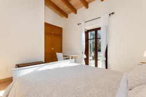 a white bedroom with a bed and a window at YourHouse Son Tey Villa in Sineu +20 photos