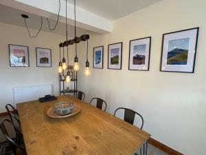 a dining room with a wooden table and chairs at Riverside in Brecon