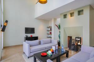 a living room with two couches and a table at Al Maaden Villa Hotel & Spa in Marrakesh