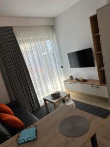 a living room with a couch and a table at Orange Luxury apartment in agrinio in Agrinio