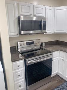 a kitchen with a stove and a microwave at Brand new en-suite private bath next Camden yard , convention center in Baltimore