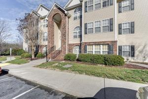 a apartment building with a sidewalk in front of it at Winston-Salem Condo with Balcony Steps to Golf! in Winston-Salem