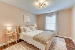 a bedroom with a large bed and a window at Winston-Salem Condo with Balcony Steps to Golf! in Winston-Salem