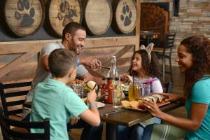 a group of people sitting around a table in a restaurant at Great Wolf Lodge Kansas City in Kansas City