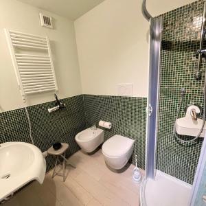 a bathroom with a toilet and a sink and a shower at Guest-House Del Corso in Montepulciano