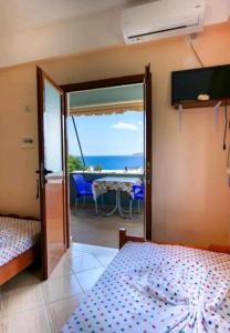 a room with two beds and a view of the ocean at Kalemi Sunrise Studios in Borsh