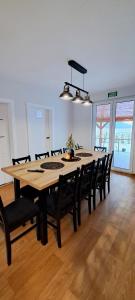 a large dining room table with black chairs and a table and chairsktop at Noclegi u Lidki 