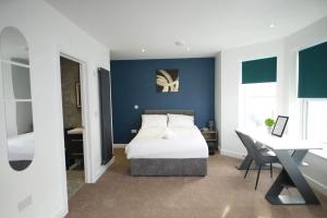 a bedroom with a bed and a desk and a desk at The Get Away in Great Yarmouth