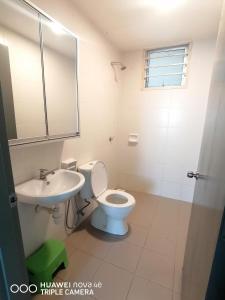 a bathroom with a toilet and a sink at JANNAH HOMESTAY ii in Putrajaya