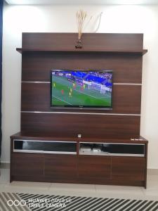 a large entertainment center with a television in a living room at JANNAH HOMESTAY ii in Putrajaya