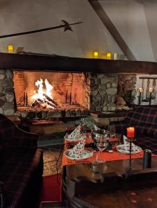 a table in a restaurant with a fireplace at Traumschloss für Feste & Feiern in Langrickenbach