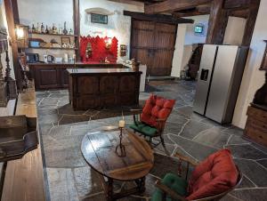 a kitchen with a table and chairs and a refrigerator at Traumschloss für Feste & Feiern in Langrickenbach