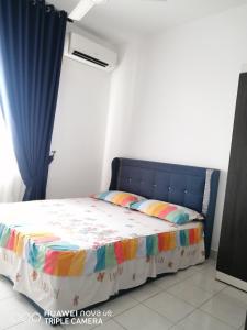 a bedroom with a bed with a blue curtain at JANNAH HOMESTAY ii in Putrajaya