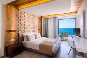 1 dormitorio con cama, escritorio y ventana en Aegean Infinity Deluxe en Limenaria