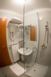 a bathroom with a glass shower and a sink at Guest Accommodation Primula in Nova Gorica