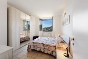 a bedroom with a bed and a large window at Casa Max in Levanto